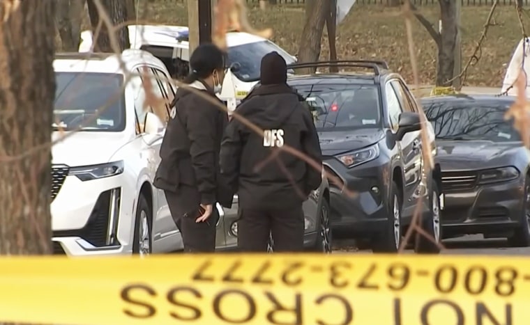 Members of the District of Columbia Department of Forensic Sciences investigate the crime scene of a shooting in Washington, D.C.