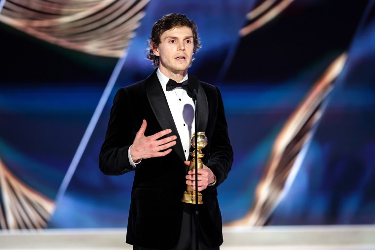 Evan Peters accepts the Golden Globe for best actor in a limited or anthology series or television film for "Dahmer — Monster: The Jeffrey Dahmer Story"  on Tuesday.