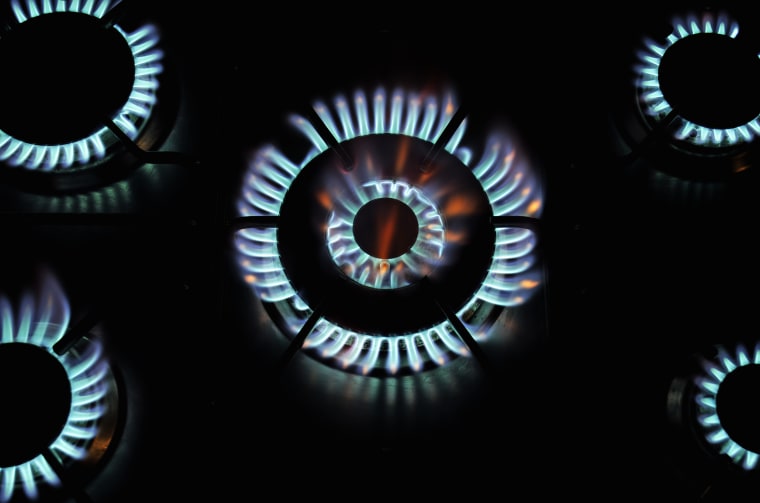 Five lit blue gas rings  