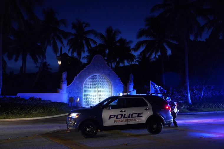 Police stand outside an entrance to former President Donald Trump's Mar-a-Lago estate