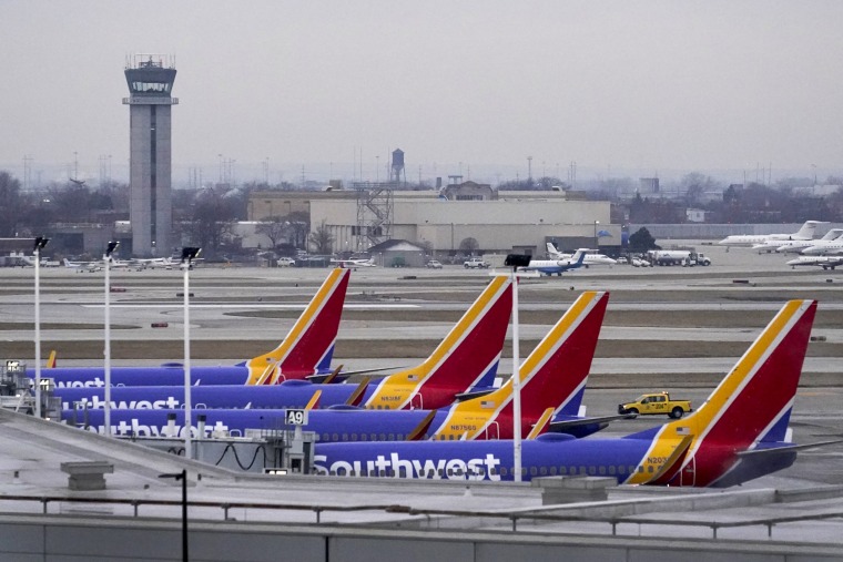 Four Southwest Airlines passenger jets sit at their gates at Chicago's Midway Airport as flight delays stemming from a computer outage at the Federal Aviation Administration has brought departures to a standstill on Jan. 11, 2023.