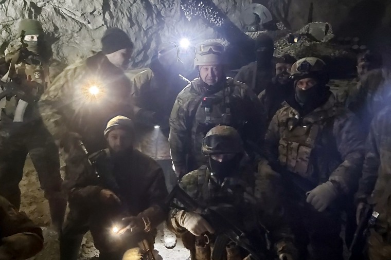 Wagner chief Yevgeny Prigozhin, center, with soldiers in what they said was a salt mine in Soledar, Ukraine in this image released on Jan. 11. 