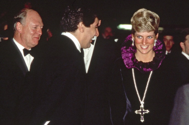 Diana, Princess Of Wales, arrives at a charity gala wearing a gold and amethyst crucifix in 1987.