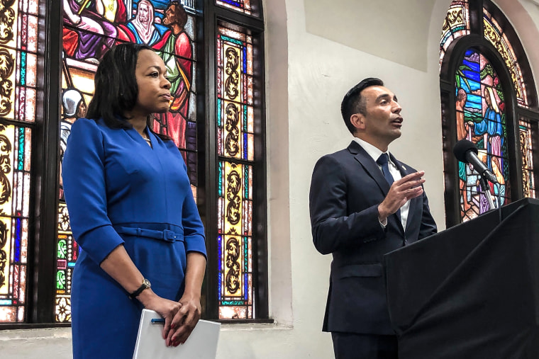Image: Assistant Attorney General of the U.S. Department of Justice's Civil Rights Division Kristen Clarke, left, listens as United States Attorney Martin Estrada, of the California central division, speaks during a news conference on Jan. 12, 2023, at the Second Baptist Church in Los Angeles.