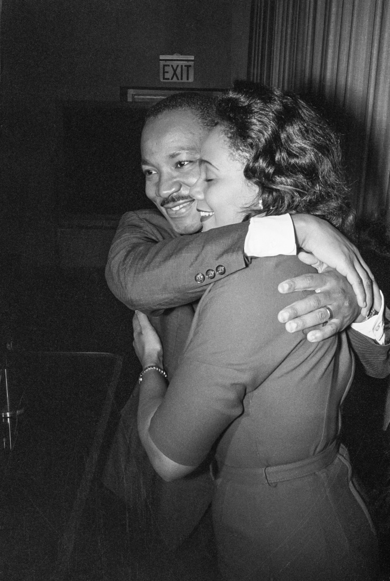 Dr. Martin Luther King, Jr., embraces his wife, Coretta, during a press conference following the announcement of his Nobel Peace Prize award on October 14, 1964.