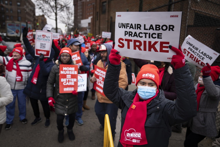 Protestors march on the streets around Montefiore Medical Center during a nursing strike in Bronx