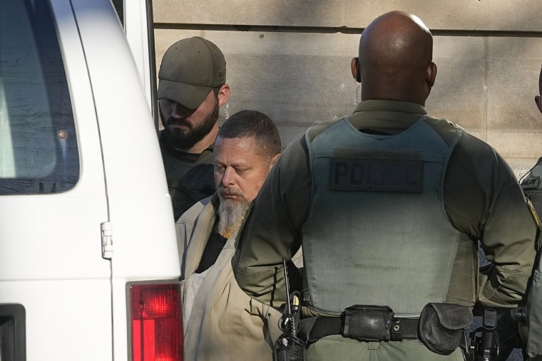 Officers escort Richard Matthew Allen following a hearing, on Nov. 22, 2022, in Delphi, Ind.