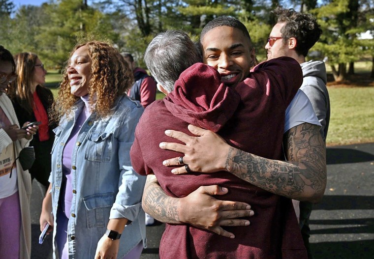 Keith Davis Jr. hugs supporter Peggy Amaker as he arrives at a gathering following his release from custody in Baltimore.
