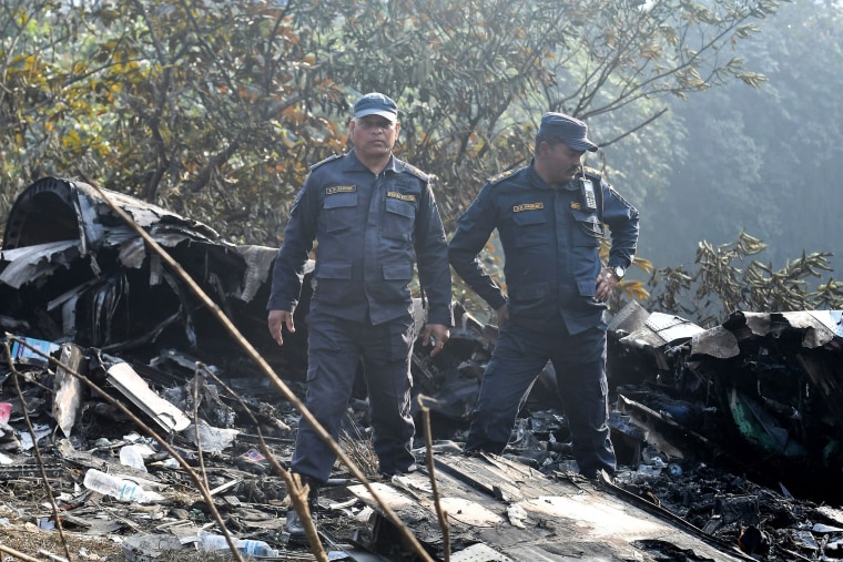 Rescuers inspect the wreckage of a plane crash in Pokhara, Nepal, on Jan. 15, 2023.