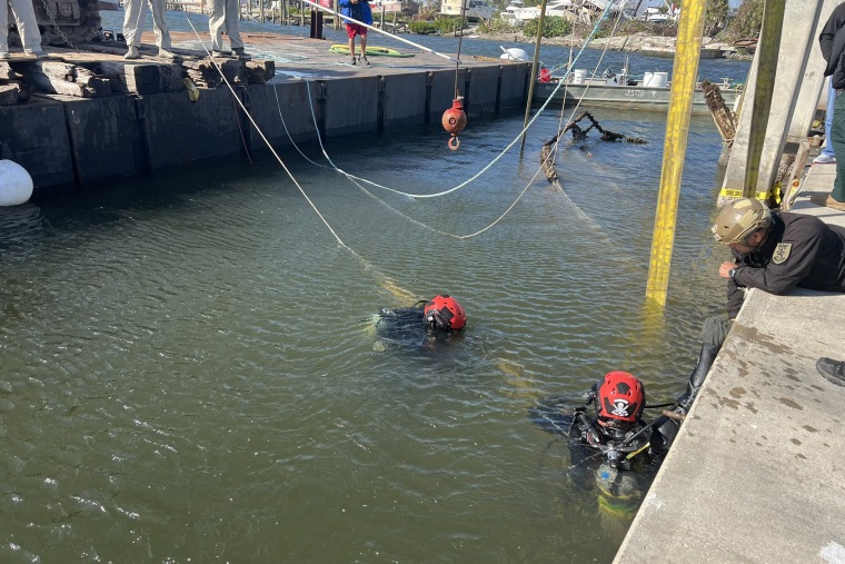 A dive team searches the wreckage of a sunken ship in Matanza's Pass in Fort Myers, Fla., on Friday. 