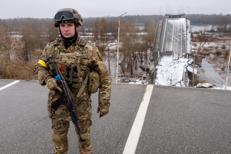 Sr. Lt. Anton stands by a destroyed bridge between Ukraine and Belarus amid growing fears of a new Russian offensive stemming from Moscow's close ally. 