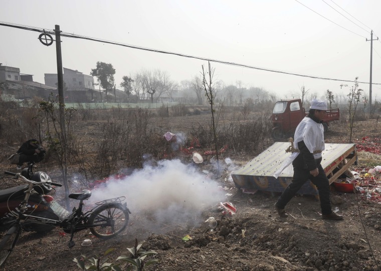 Chinese pray for health in Lunar New Year as Covid death toll rises