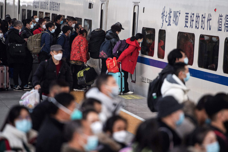 Passengers prepare to board a train at Hankou railway station in central China on Jan. 7, 2023 ahead of the Lunar New Year.