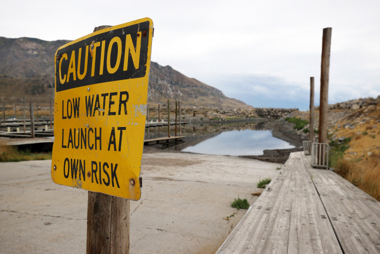 A caution sign is posted near a boat launch ramp at the Great Salt Lake State Park