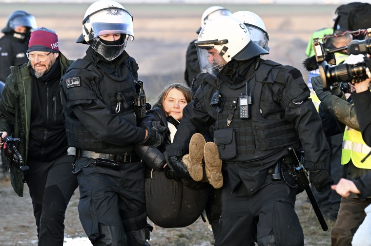Police officers carry Swedish climate activist Greta Thunberg away from a mine during a protest by climate activists in Luetzerath, Germany, on Jan. 17, 2023. 