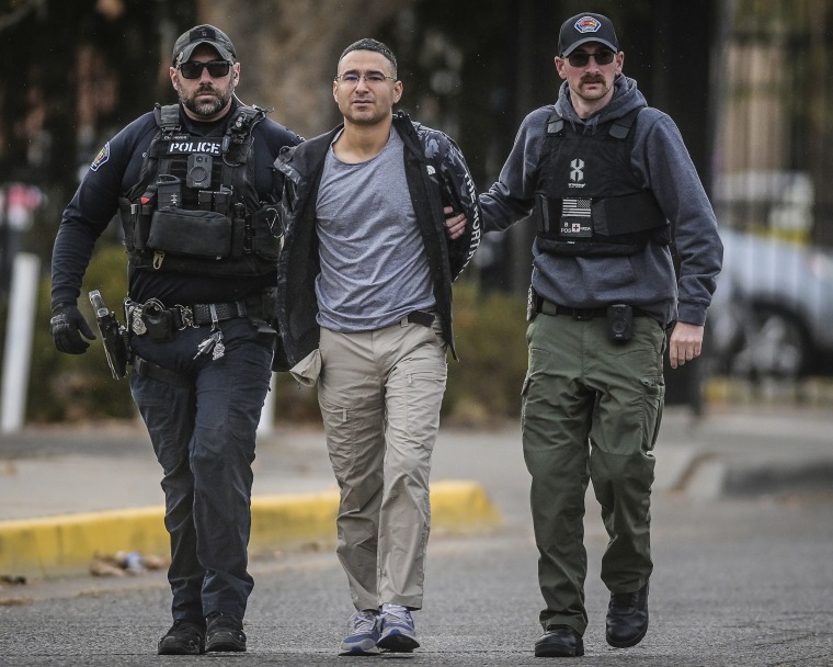 Solomon Pena, center, a Republican candidate for New Mexico House District 14, is taken into custody by Albuquerque Police officers, on Jan. 16, 2023, in southwest Albuquerque, N.M.