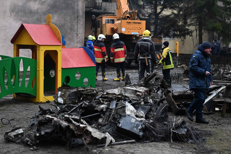 Firefighters work at the site where a helicopter crashed near a kindergarten in Brovary, Ukraine on Wednesday. 
