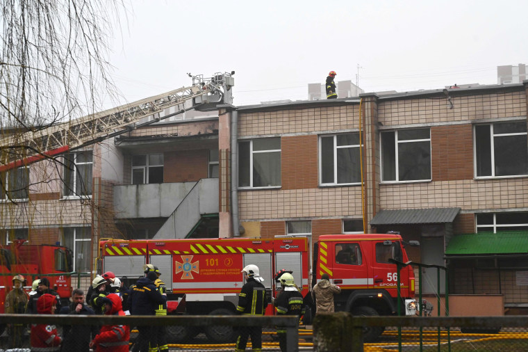 Firefighters work at the site where the helicopter crashed near a kindergarten on Wednesday. 