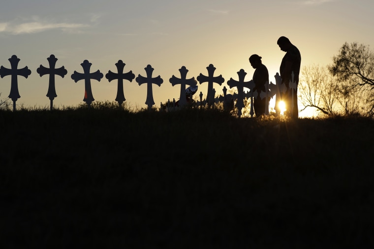 Kenneth and Irene Hernandez pay their respects as they visit a makeshift memorial with crosses placed near the scene of a shooting at the First Baptist Church of Sutherland Springs, Monday, Nov. 6, 2017, in Sutherland Springs, Texas. A man opened fire inside the church in the small South Texas community on Sunday, killing and wounding many. (AP Photo/Eric Gay)