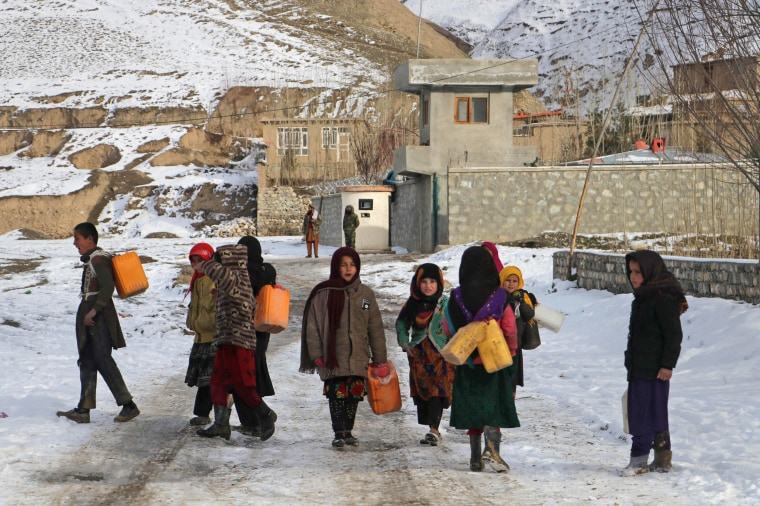 Children carry containers to fetch drinking water in Afghanistan's Badakhshan Province on Jan. 18, 2023.
