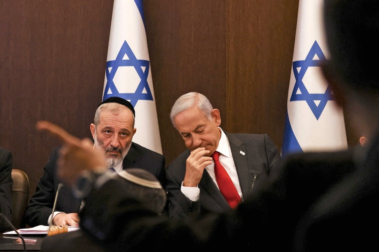 Israel's Prime Minister Benjamin Netanyahu, right, sits next to Interior and Health Minister Aryeh Deri during a weekly cabinet meeting at the Prime Minister's office in Jerusalem on Jan. 8, 2023. 