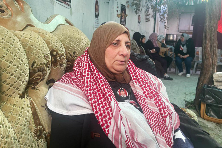 Suhad Khamour sits with women offering their condolences in Dheisheh, outside Bethlehem.