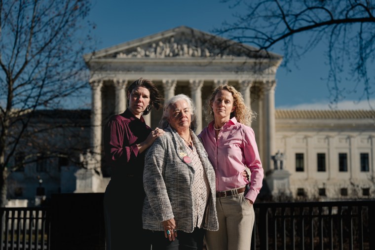 Pro-abortion rights activists Nicole Enfield, left, Rolande Baker, and Emily Paterson before their sentencing on Jan. 13 for interrupting judicial proceedings during a Nov. 2 Supreme Court hearing. The activists were photographed outside the area from which they are banned.