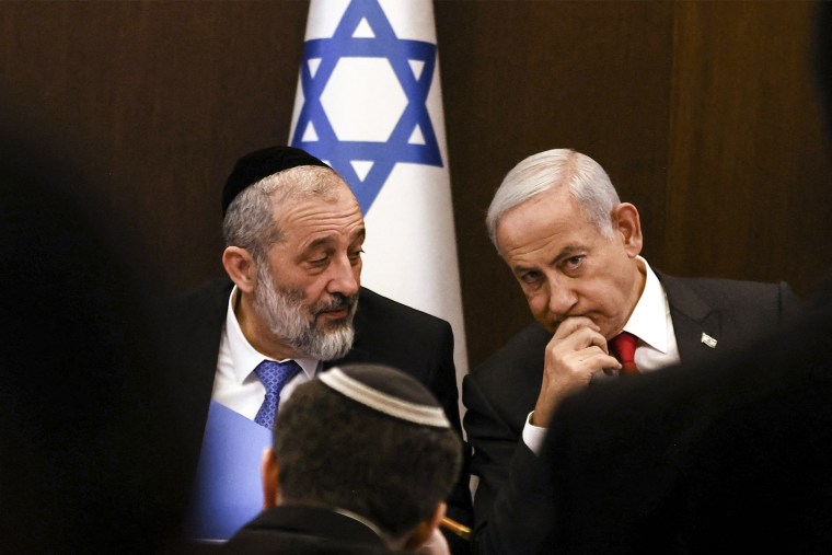  Israel's Prime Minister Benjamin Netanyahu sits next to Interior and Health Minister Aryeh Deri during a weekly cabinet meeting at the Prime Minister's office in Jerusalem on Jan. 8, 2023.