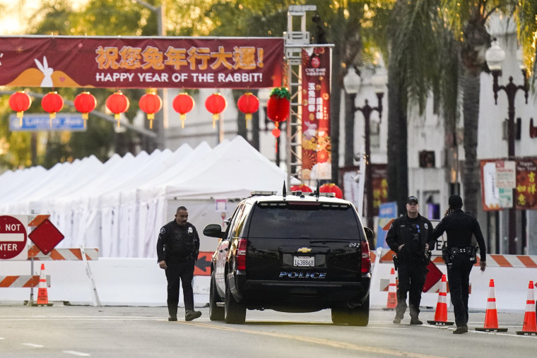 Police officers stand outside a ballroom dance club in Monterey Park, Calif., on Jan. 22, 2023.