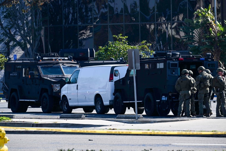 Law enforcement personnel surround a white van in Torrance, Calif., on Jan. 22, 2023.