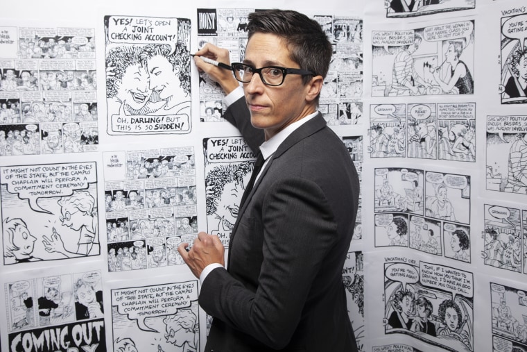Alison Bechdel with BG wall of her comics.