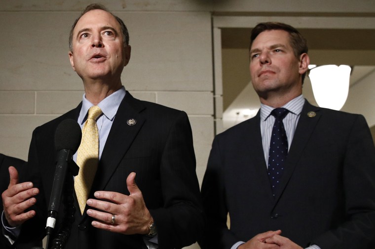 FILE - In this May 28, 2019 file photo, Rep. Adam Schiff, D-Calif., left, and Rep. Eric Swalwell, D-Calif., speak with members of the media on Capitol Hill in Washington.  The Justice Department under former President Donald Trump secretly seized data from the accounts of at least two Democratic lawmakers in 2018 as part of an aggressive crackdown on leaks related to the Russia investigation and other national security matters, according to three people familiar with the seizures.  (AP Photo/Patrick Semansky)