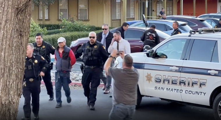 Chunli Zhao being arrested Monday in the parking lot of the San Mateo County Sheriff’s Office as a suspect in the mass shooting in Half Moon Bay earlier in the day.