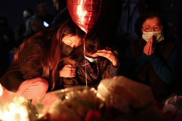 People gather at a candlelight vigil   for victims of a  mass shooting at a ballroom dance studio in Monterey Park, Calif.