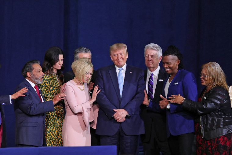 Faith leaders pray over President Donald Trump during a "Evangelicals for Trump" campaign event at the King Jesus International Ministry on Jan. 3, 2020 in Miami.