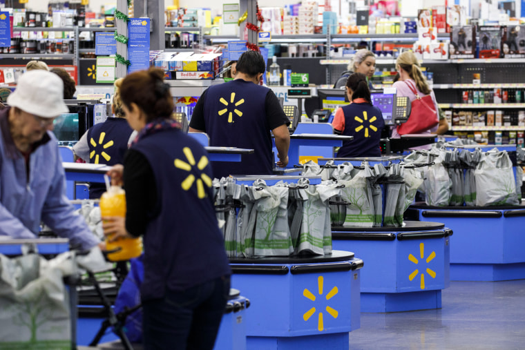 Cashiers ring up shoppers at a Walmart store in Burbank, Calif., on Nov. 19, 2018.