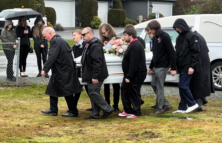 Image: Pallbearers carry Taylor Goodridge's casket at her funeral.