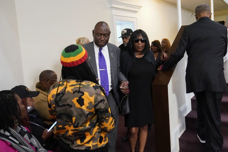 RowVaughn Wells, center, arrives at a news conference with civil rights Attorney Ben Crump