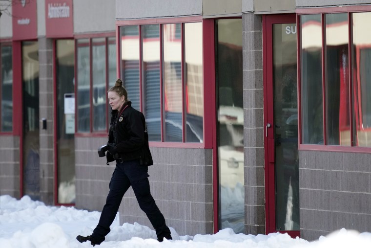 A law enforcement officer exits the Starts Right Here building, Monday, Jan. 23, 2023, in Des Moines, Iowa. Police say two students were killed and a teacher was injured in a shooting at the Des Moines school on the edge of the city's downtown.