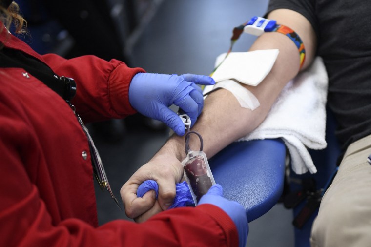 A person donates blood in the LA Kings blood mobile in Los Angeles