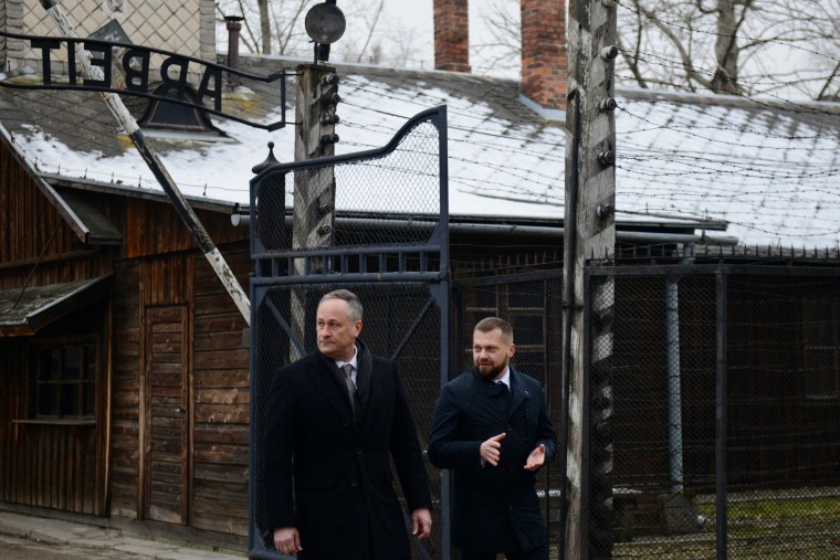 Second Gentleman of the United States Douglas Emhoff, left, walks through the camp's main gate at the Memorial and Museum Auschwitz-Birkenau, on Holocaust Remembrance Day, Friday. 