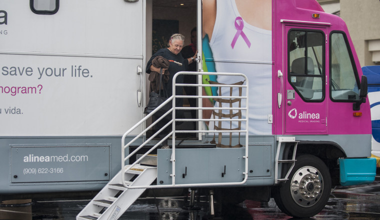 A woman exits a mobile mammography screening bus in Anaheim, California.