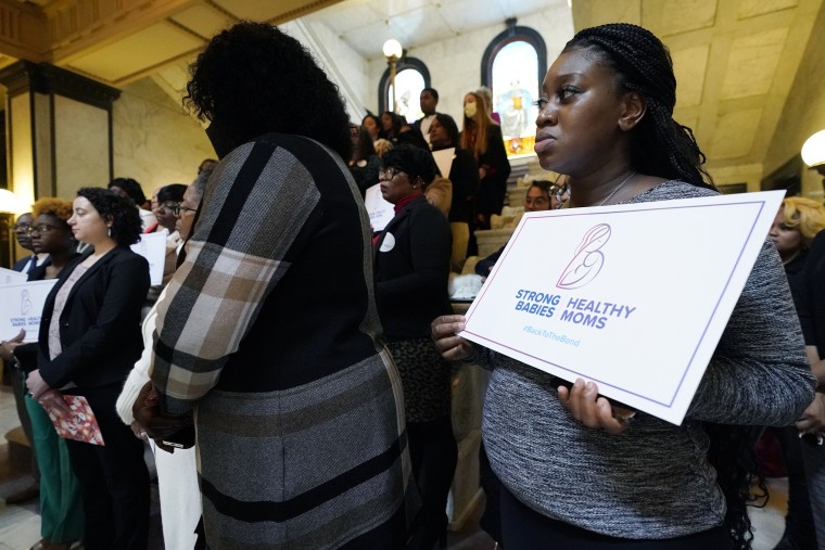 Velvet Johnson holds a sign calling for support of the Mississippi Black Women's Roundtable legislative agenda