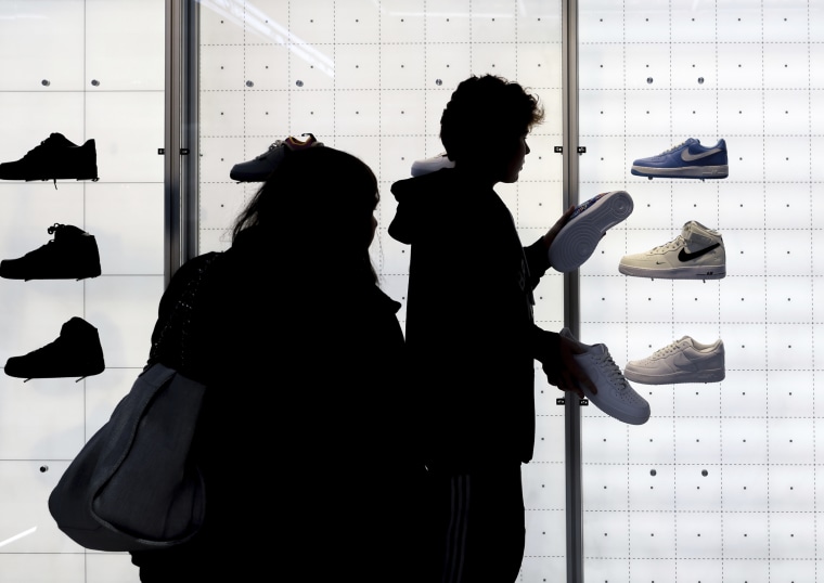 People shop for shoes in a Nike store in New York