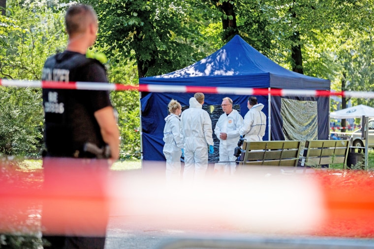 Forensic experts work at the crime scene site of the murder of Zelimkhan Khangoshvili