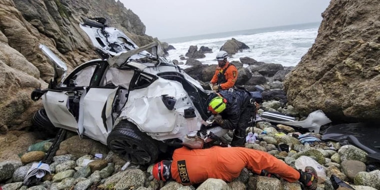Emergency personnel respond to a vehicle over the side of Highway 1 on Sunday, Jan. 1, 2023, in San Mateo County, Calif.