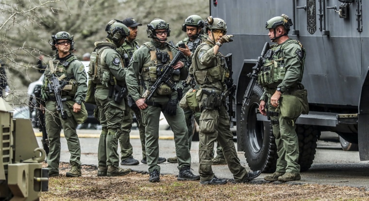 DeKalb and Atlanta SWAT members leave the Gresham Park command post in Atlanta on Jan. 18, 2023.