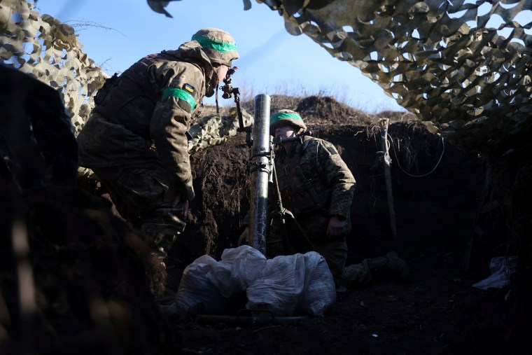 Ukrainian soldiers fire mortars from a position Bakhmut on Jan. 27, 2023.