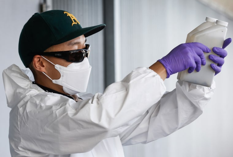 Zach Wu, a wastewater control inspector examines sewage samples that are sent to labs to analyze for any detection of the COVID-19 coronavirus in Oakland, Calif. on July 14, 2020. 