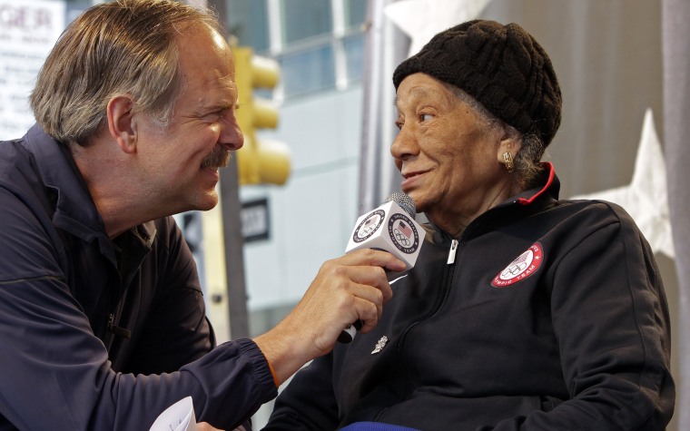 Alice Coachman, a gold medalist in the high jump at the 1948 Olympics, being interviewed by Olympic swimmer John Nabor.